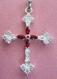 Celtic art craft hwolesaler online manufacturers presenting Botonee garnet cross pendant. Sterling silver cross with genuine semiprecious gemstone, shown in garnet. This beautiful pendant skillfully weaves the famous Botonee design into a distinctive and unusal cross centered on a high-quality garnet and cz stone. 